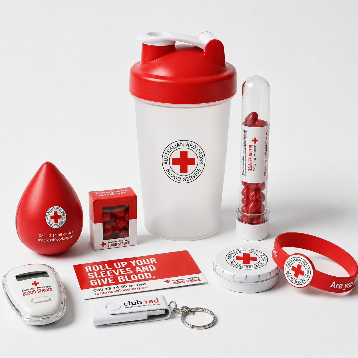 Australian Red Cross Lifeblood branded merchandise range supplied by Chilli Promotions — shaker bottle, blood-drop stress ball, lip balm, lanyard, wristband, donor cards and stress reliever