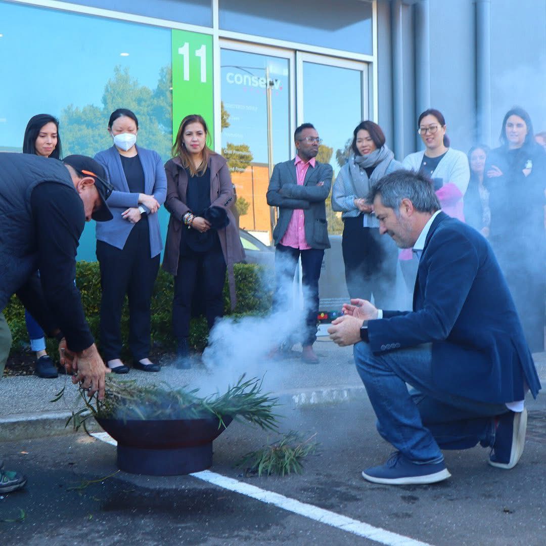 Chilli Promotions team at the Port Melbourne showroom and warehouse — designers, account managers and production team during a Welcome to Country smoking ceremony